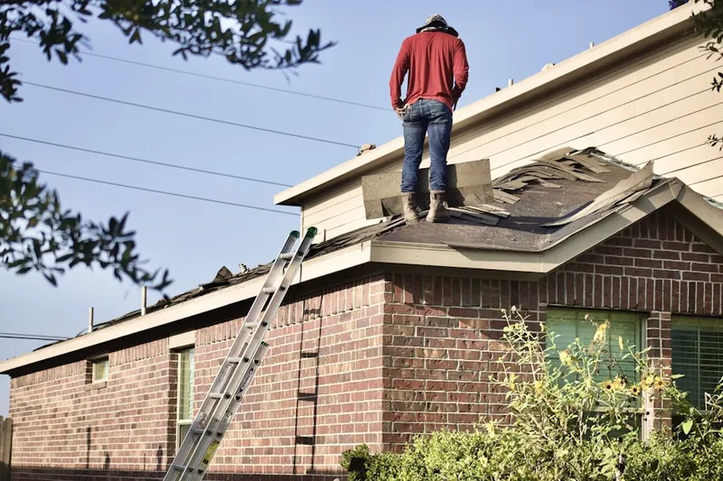 Professional roofer working on a residential roof in 441 Corridor